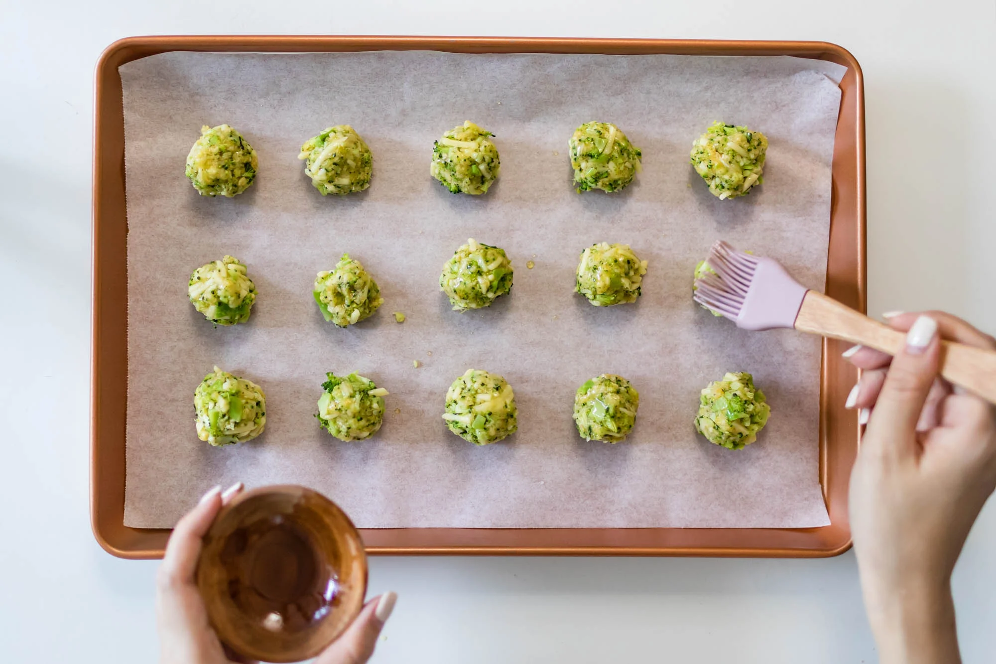 Brush the top of the balls with some olive oil.