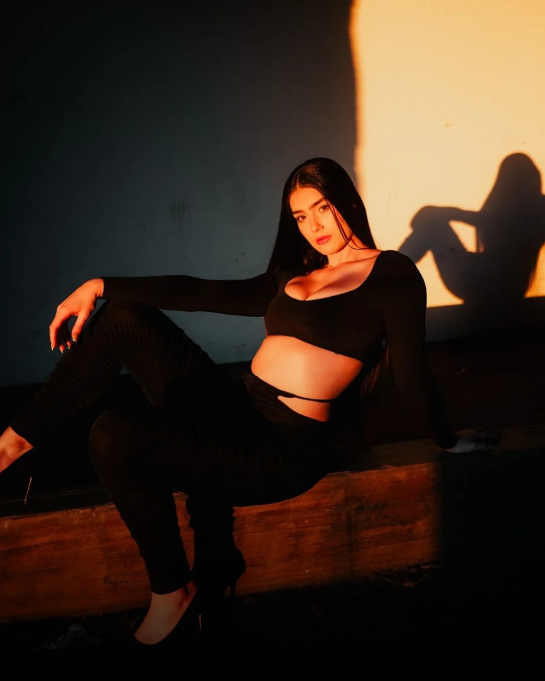 Full-body fashion model pose with creative lighting and shadow, showcasing professional modelling portfolio image composition