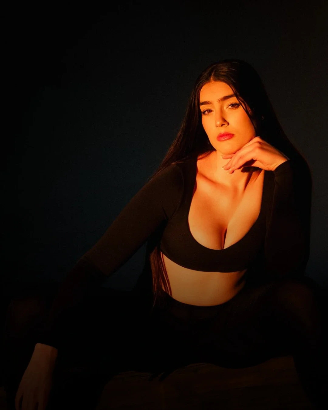 Close-up fashion model portrait with strong lighting and confident expression, ideal example of modelling portfolio headshot