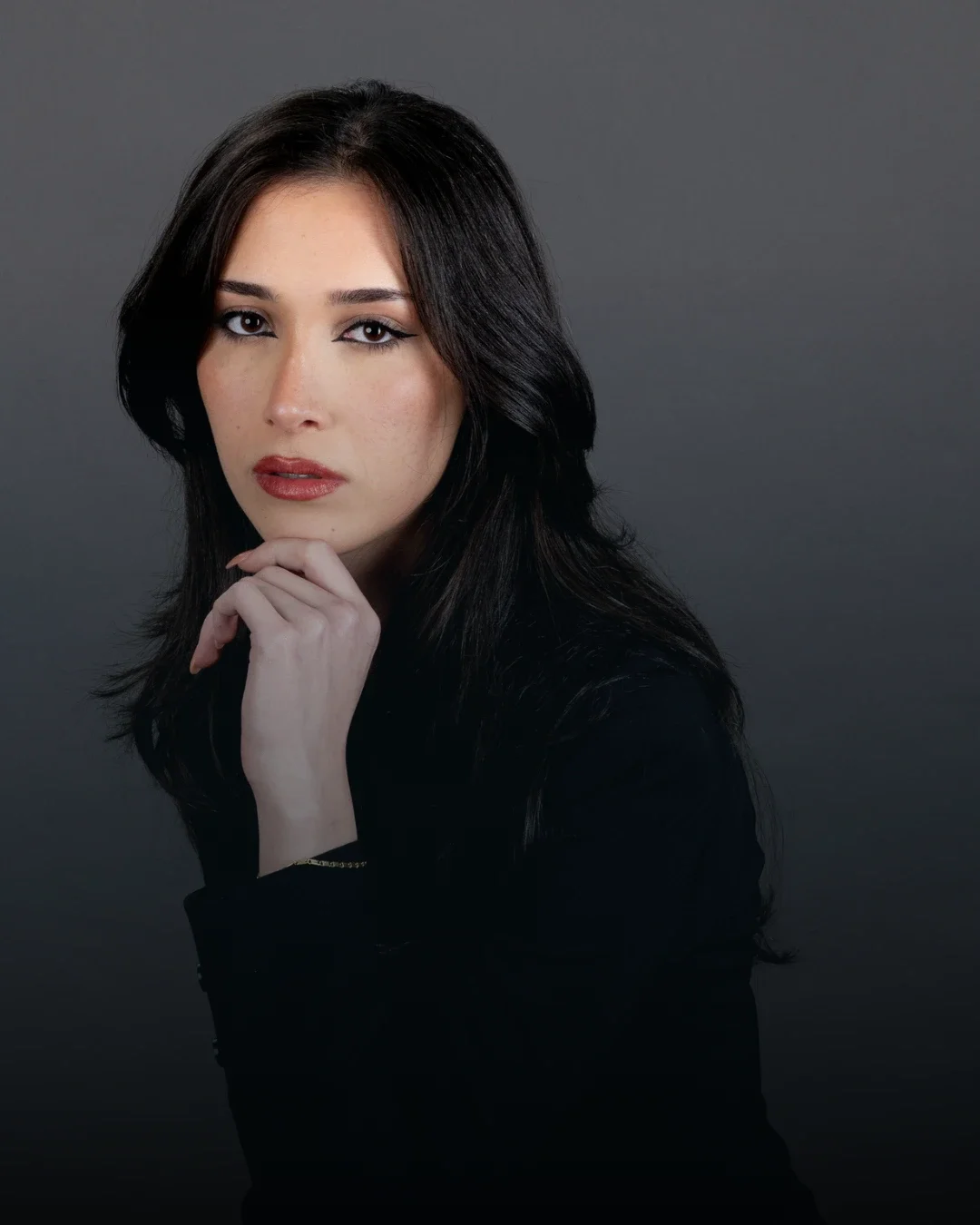 Beginner model in Australia posing confidently in blazer and dress during professional modelling training session