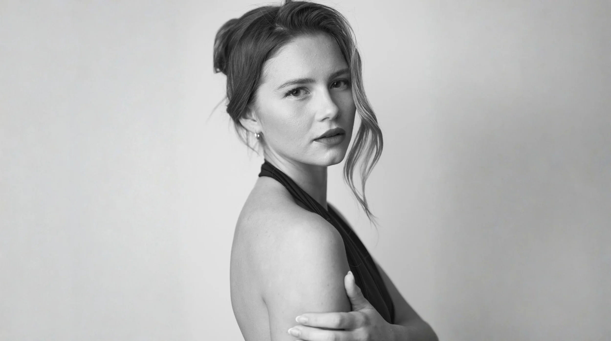 Fashion model posing confidently in a black outfit during a studio photoshoot, illustrating personal branding for models.