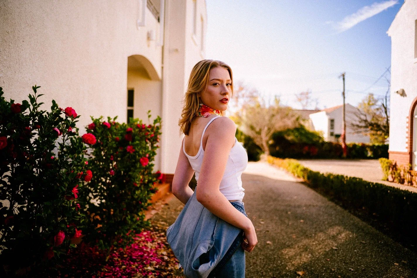 Fashion model posing outdoors in a residential setting, demonstrating confidence and professional presentation for a long-term modelling career.