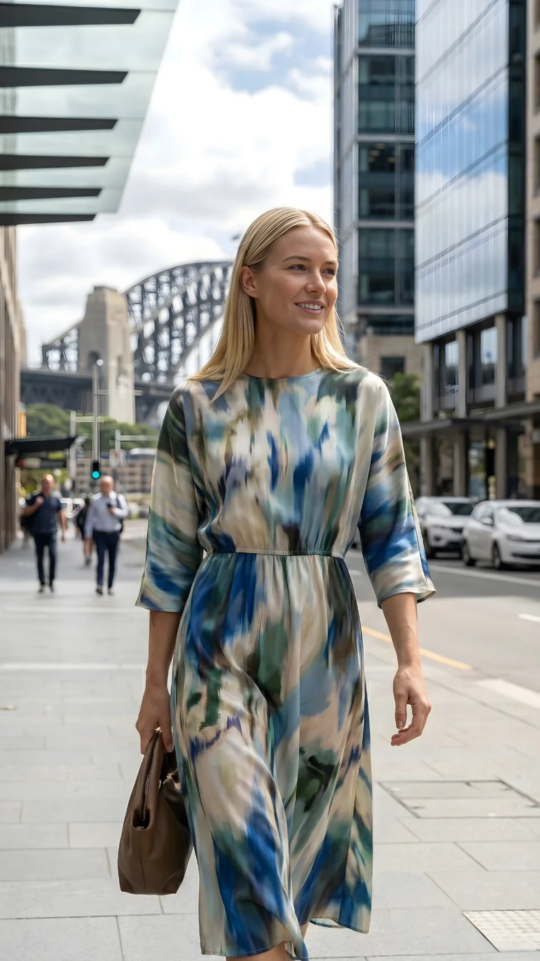 Aspiring female model walking through Sydney city streets near Harbour Bridge, representing starting a modelling career in Sydney