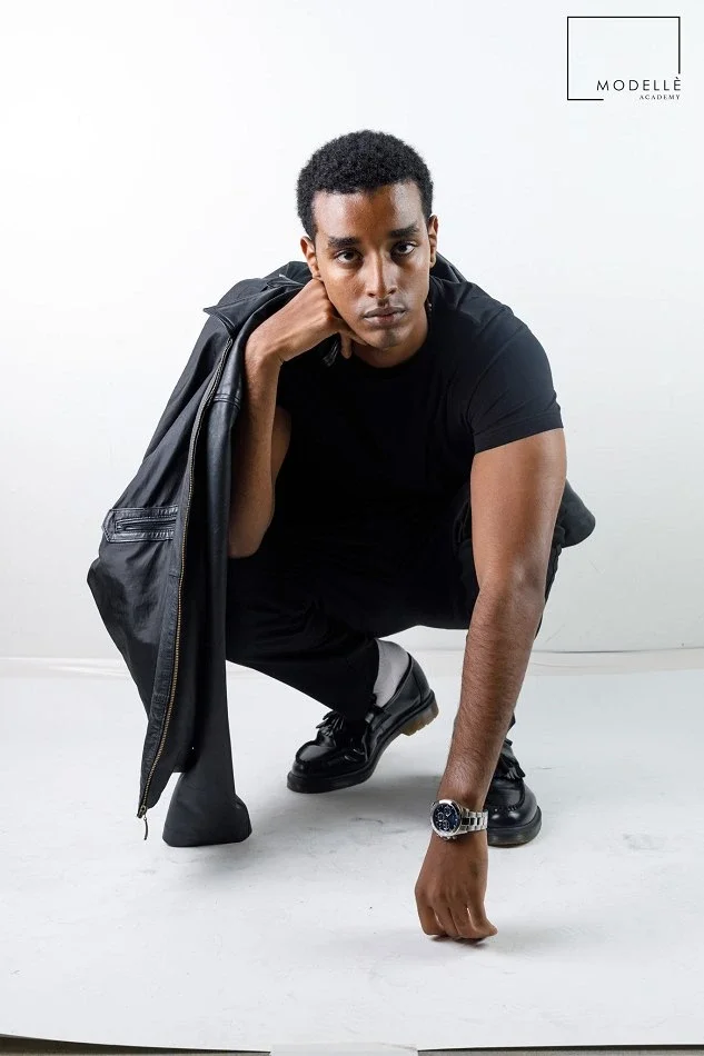 Male model showcasing confident posing, strong presence and professional modelling skills in a studio