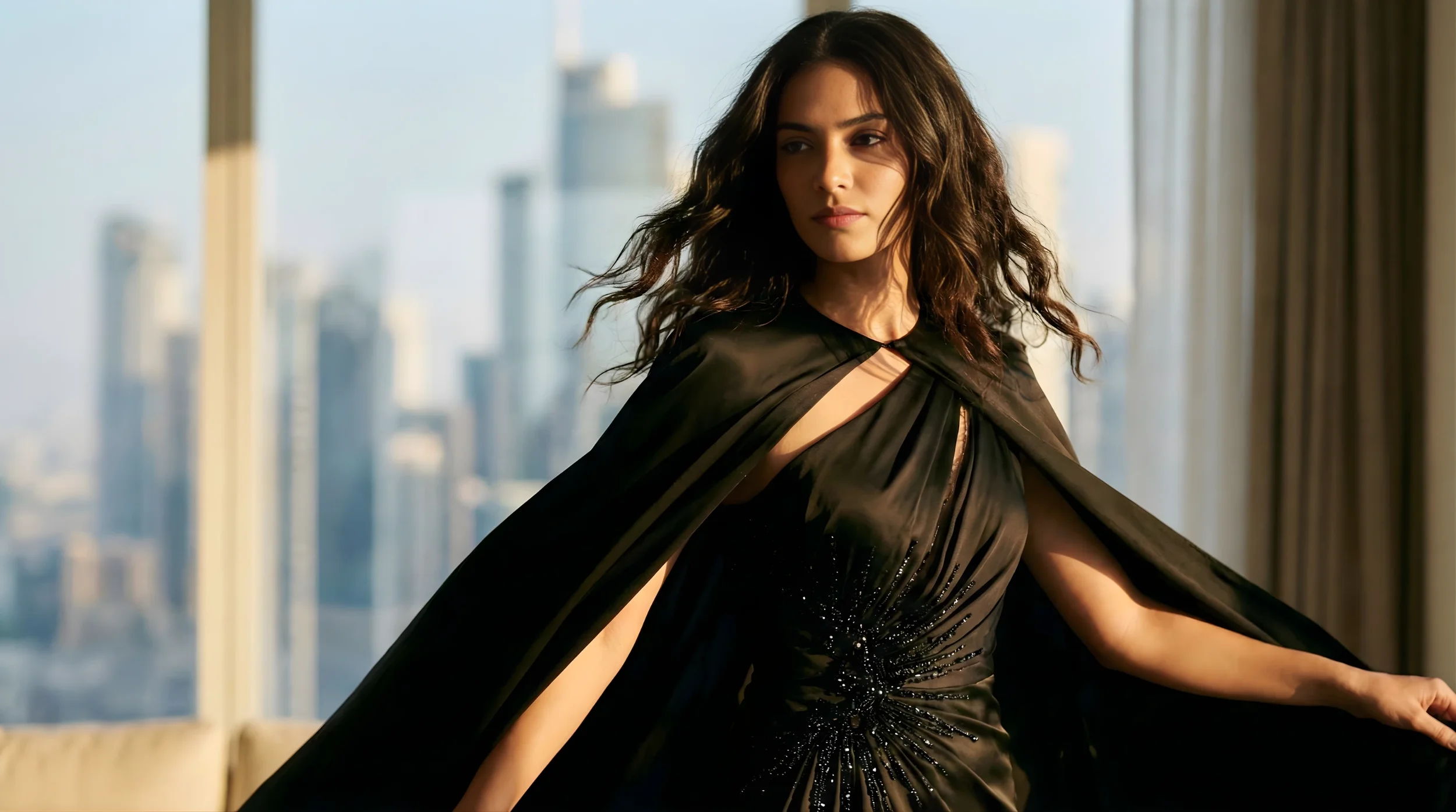 High fashion model wearing elegant black gown with city skyline backdrop, showcasing advanced stage of a successful modelling career path