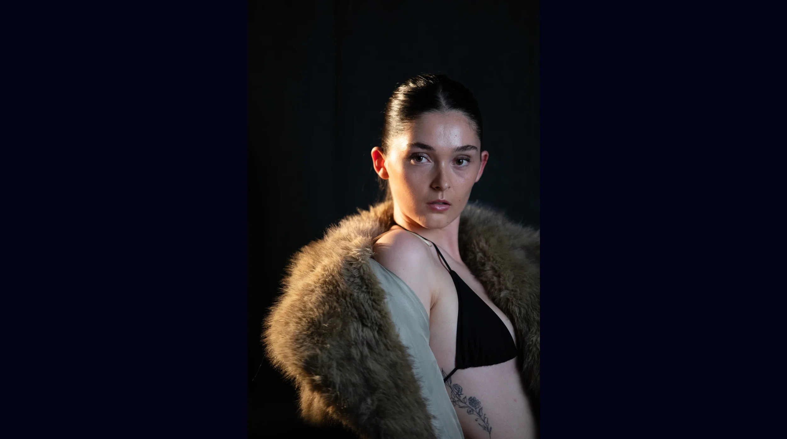 Model showcasing confident posing, expressive eye contact and editorial styling in a fashion photoshoot.