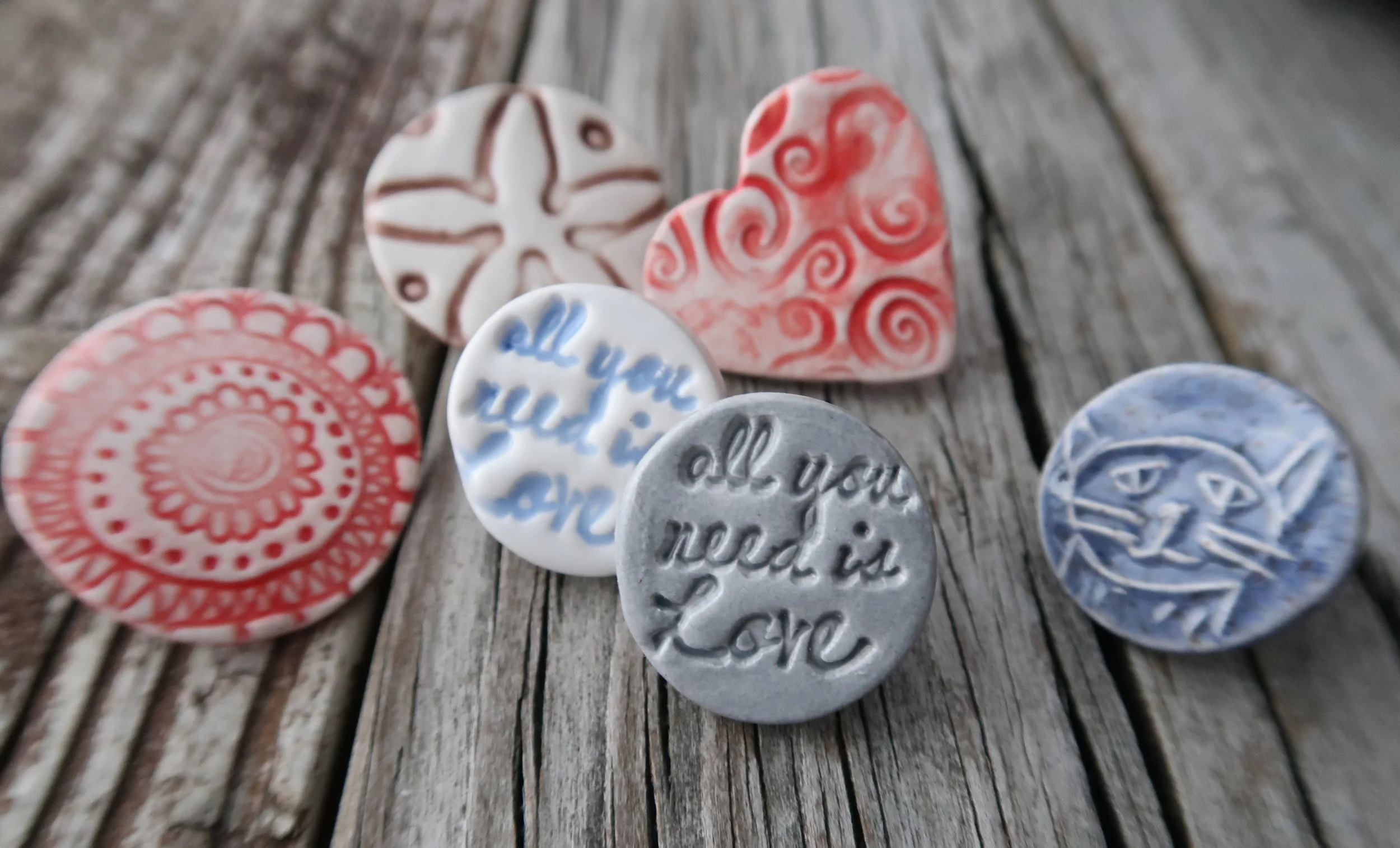 small ceramic pins for backs or backpacks as well and shirts!