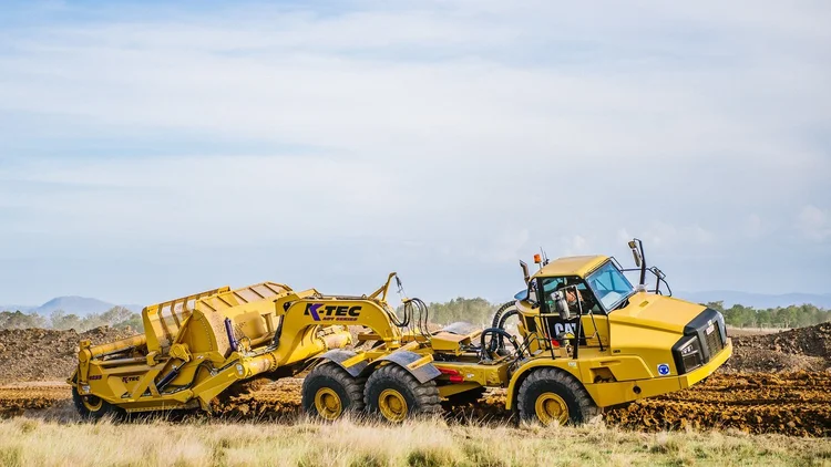 K-Tec 1237 ADT scraper paired with a CAT articulated dump truck on a Queensland earthworks site.