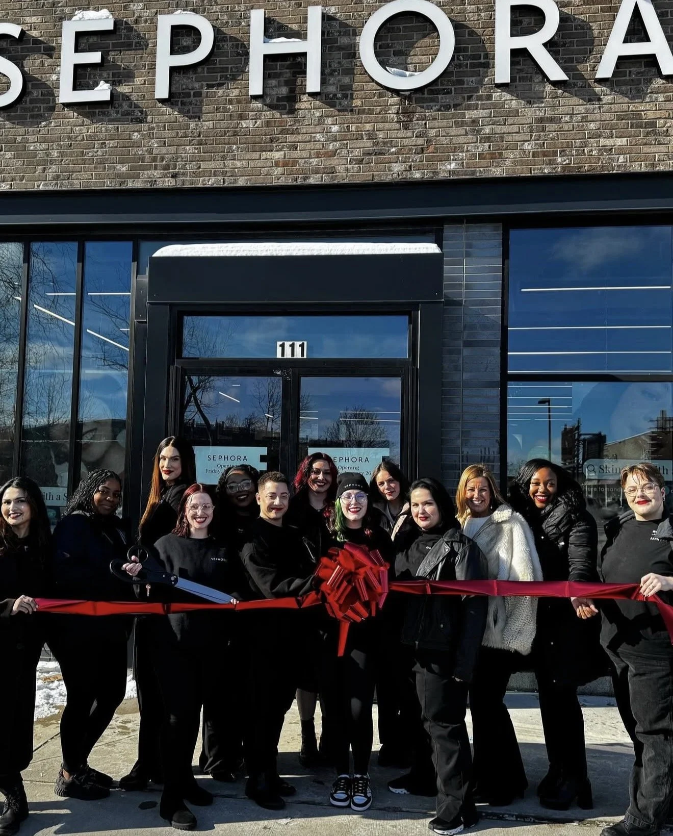 Charniece Lang celebrating her paid Sephora internship alongside her team during a ribbon-cutting event after training at Beautiful Luxe School of Cosmetology.