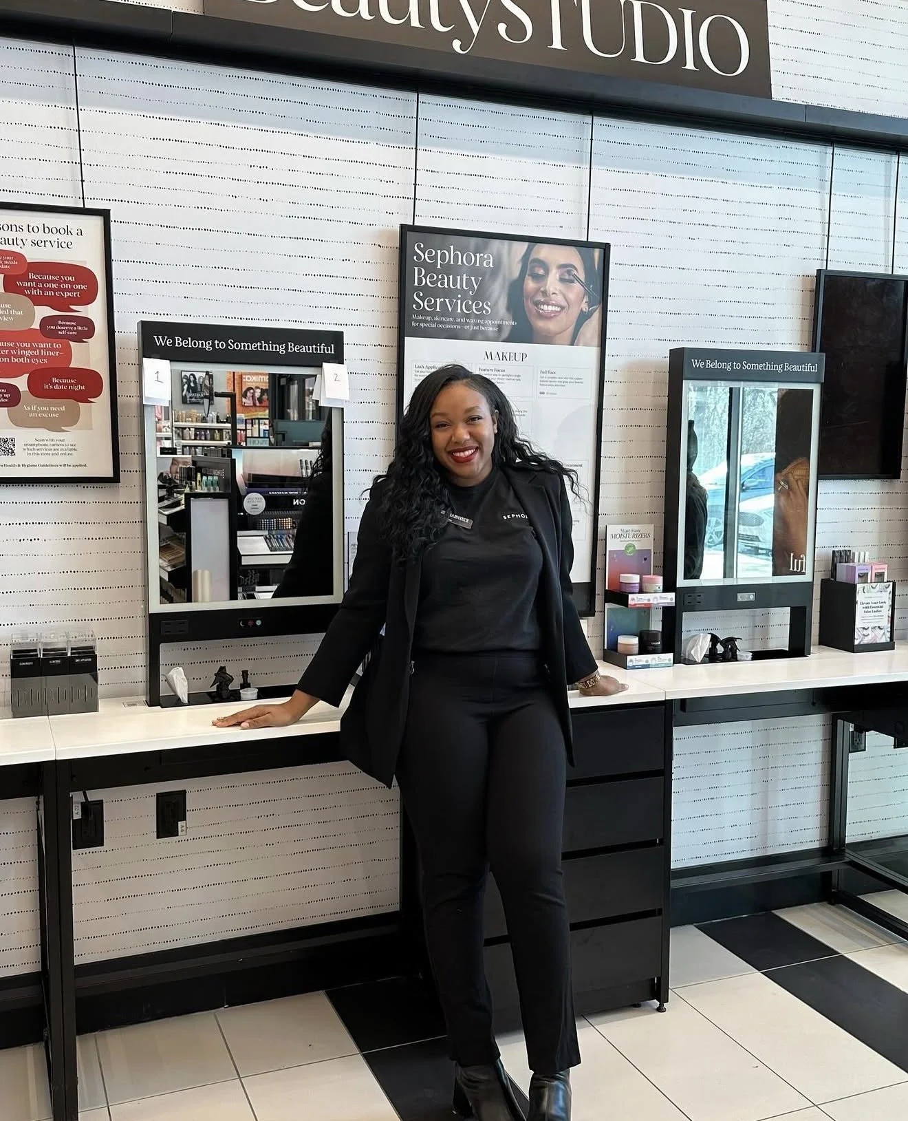 Charniece Lang standing inside the Sephora Beauty Studio during her paid internship, applying professional skills gained at Beautiful Luxe School of Cosmetology.