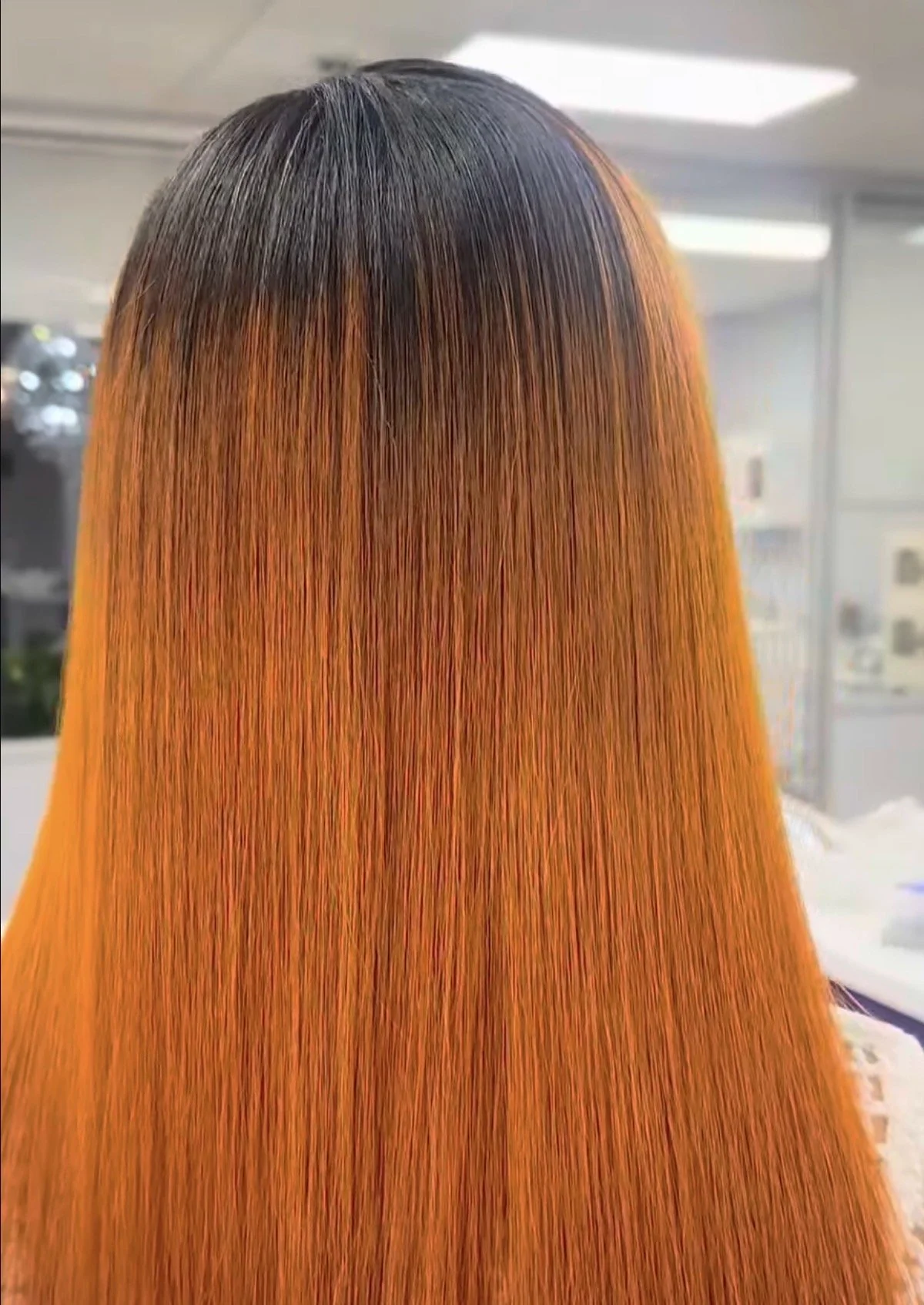 Beautiful Luxe School of Cosmetology student Charniece showcasing a smooth silk press with a copper color melt, demonstrating advanced color and straightening techniques.