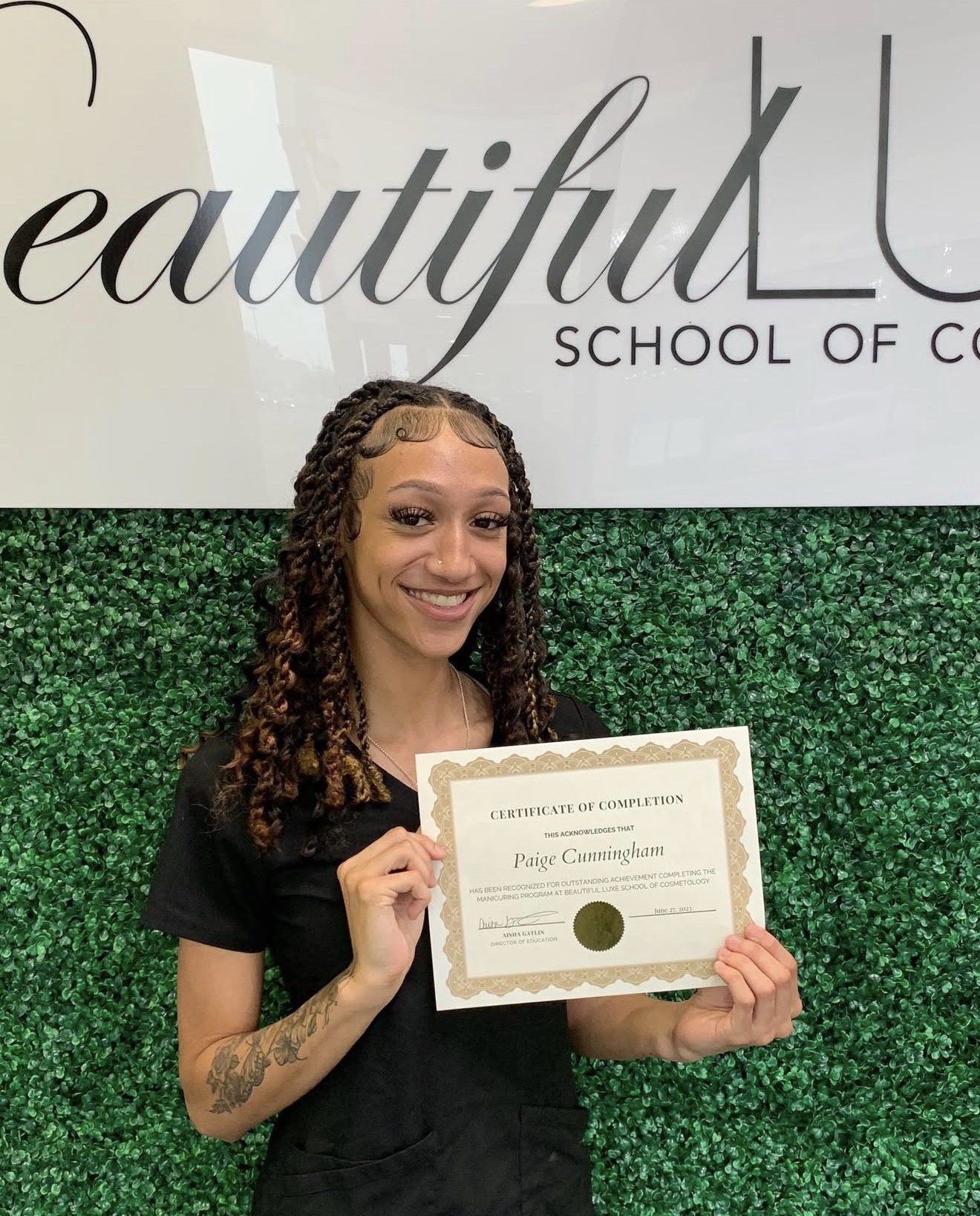 Paige, BLSC Nail Technology graduate, smiling with professional nail art