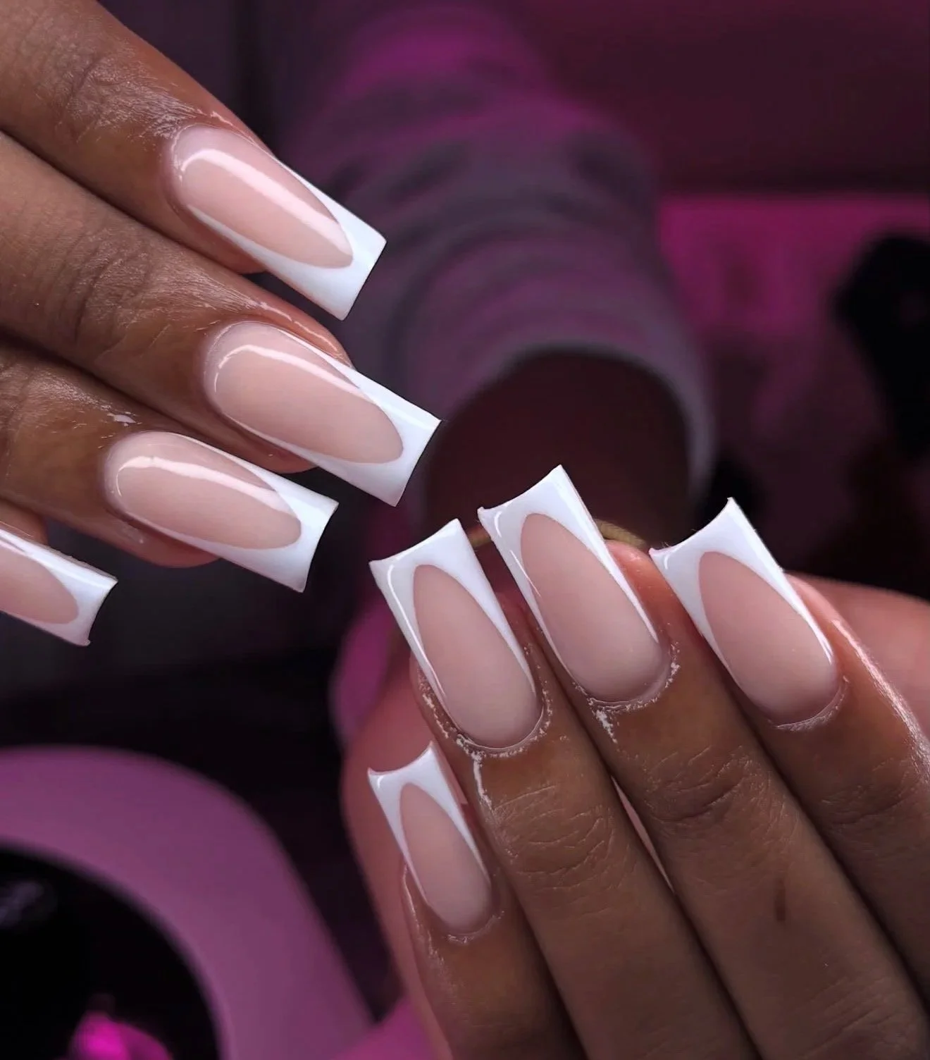 Paige performing acrylic french tip nail services for a client, showcasing her professionalism and service quality.