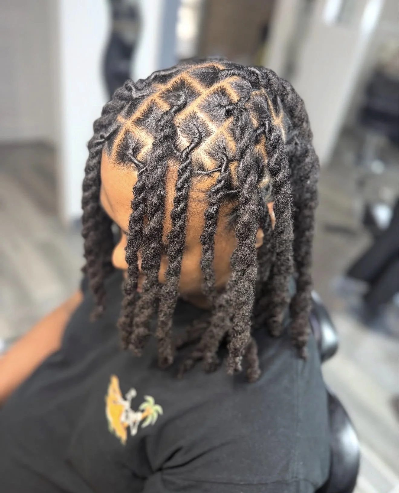 Front view of of freshly installed starter locs showcasing neat sections and healthy scalp work by Mekhiah The Loc Barber