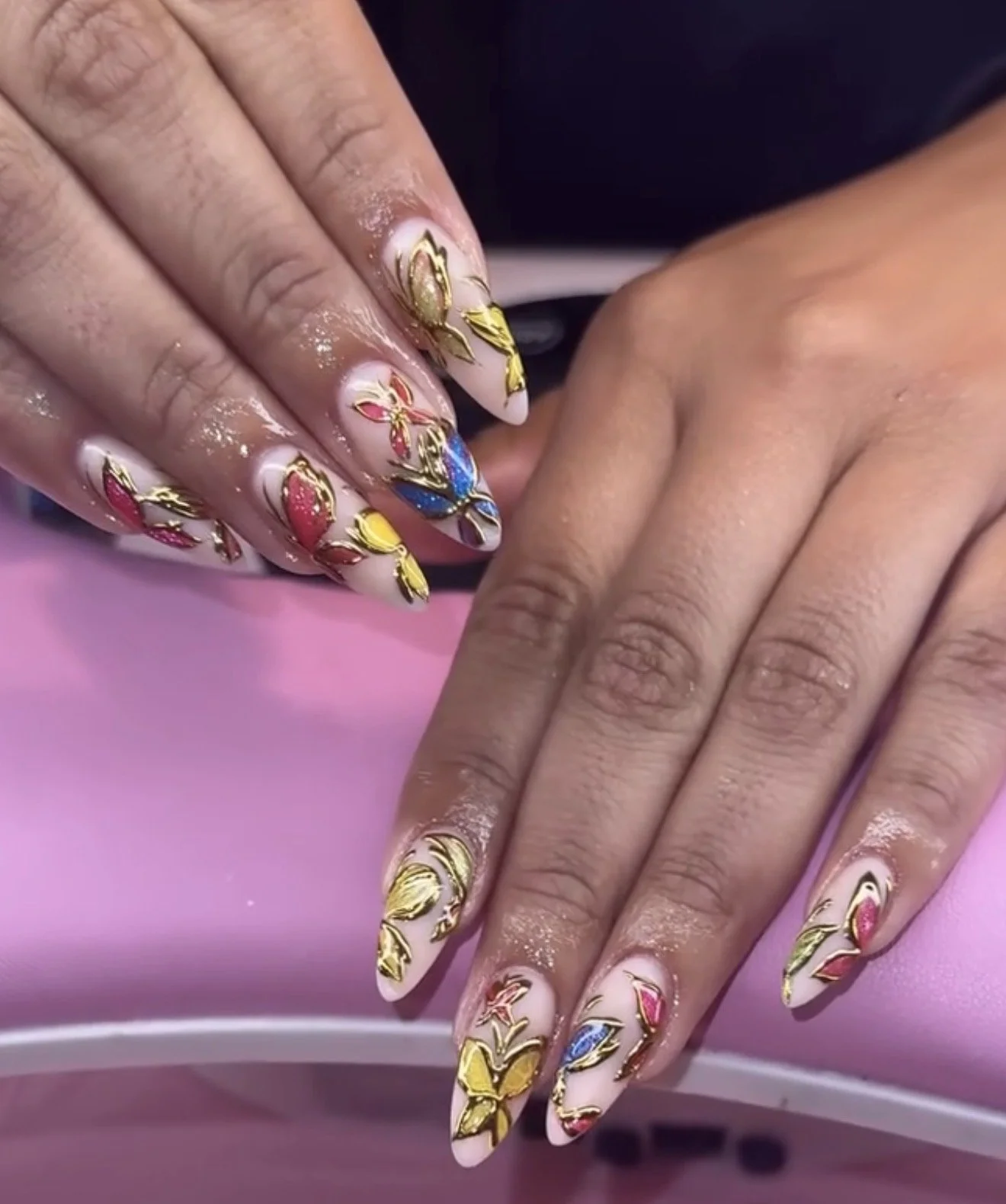 Paige demonstrating nail service techniques on a client model during hands-on training at Beautiful Luxe School.