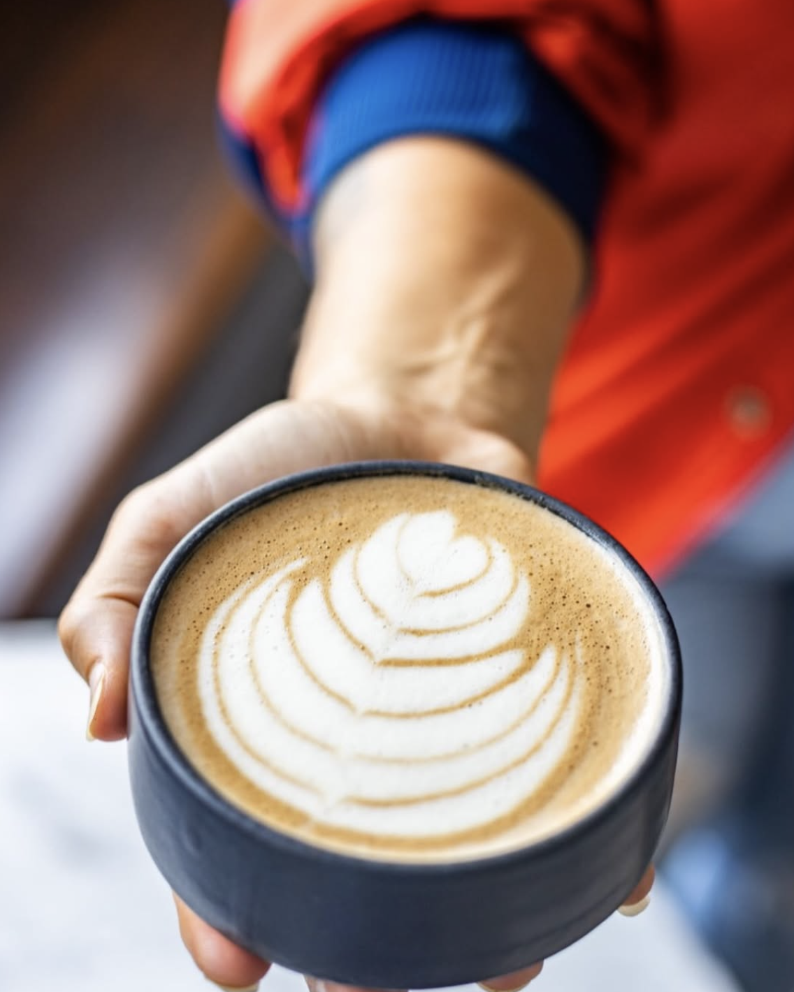  Coffee latte art at a vegan and vegetarian plant based cafe in New Orleans. Coffee drinks are organic and made with oat milk.  
