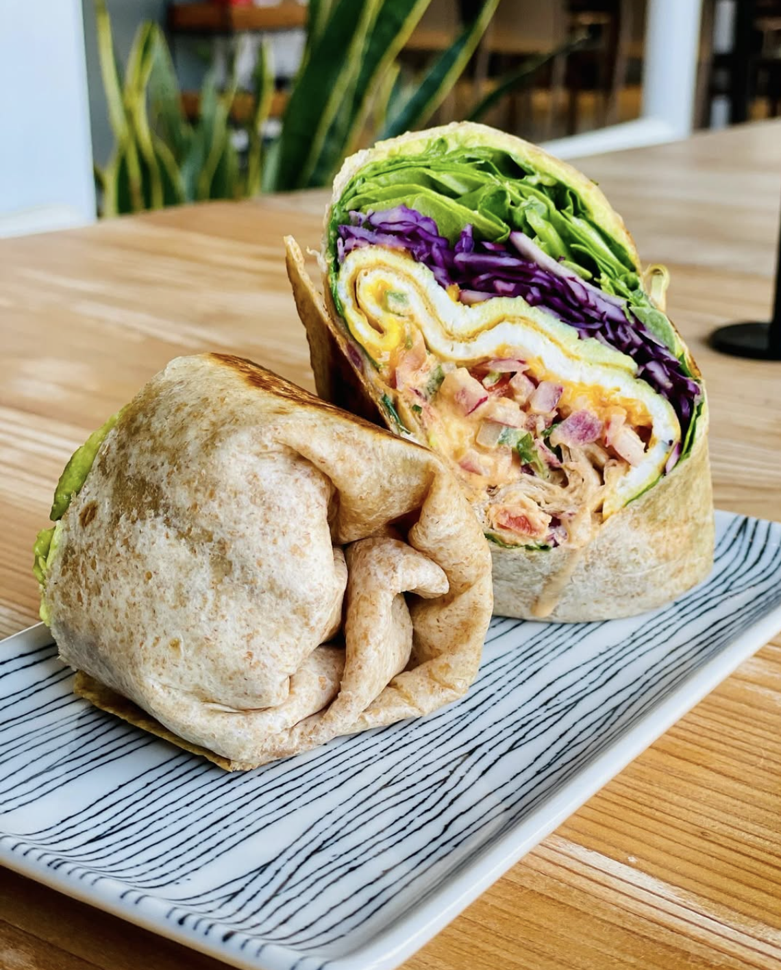  Breakfast burrito wrap at a plant based cafe in New Orleans. Wrap has eggs, veggies, sauces, all homemade and organic. Gluten free, vegan, and vegetarian options 