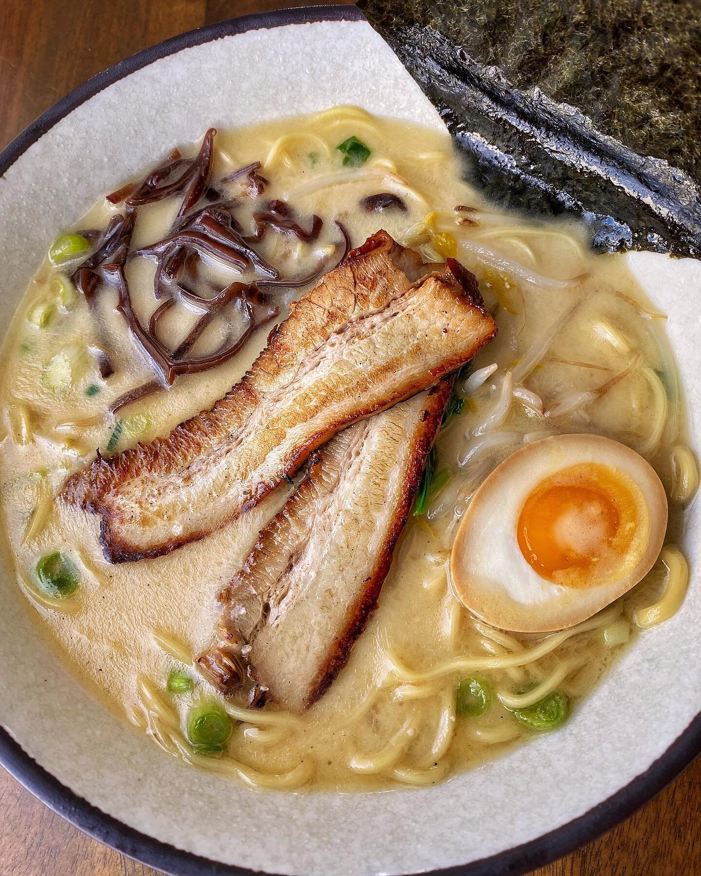 Simmered pork bone broth with our handcrafted noodles topped with bean sprouts, green onion, spinach, half egg, seaweed, wood ear mushrooms, and pork chashu grilled to perfection. 🍜🤤

Have our Tonkotsu Ramen and stop by our Irvine location for Outs