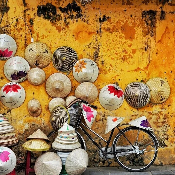 A typical sight in rural villages all over Vietnam is a person wearing a traditional conical n&oacute;n l&aacute; hat (leaf hat). Worn to protect the wearer from both the sun and rain they are hand-made from palm leaves. Both beautiful and ornate the