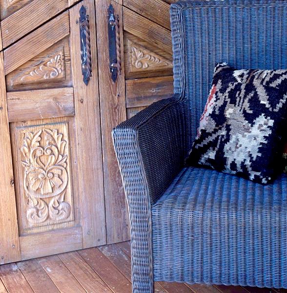 Detail wicker chair and carved door.jpeg