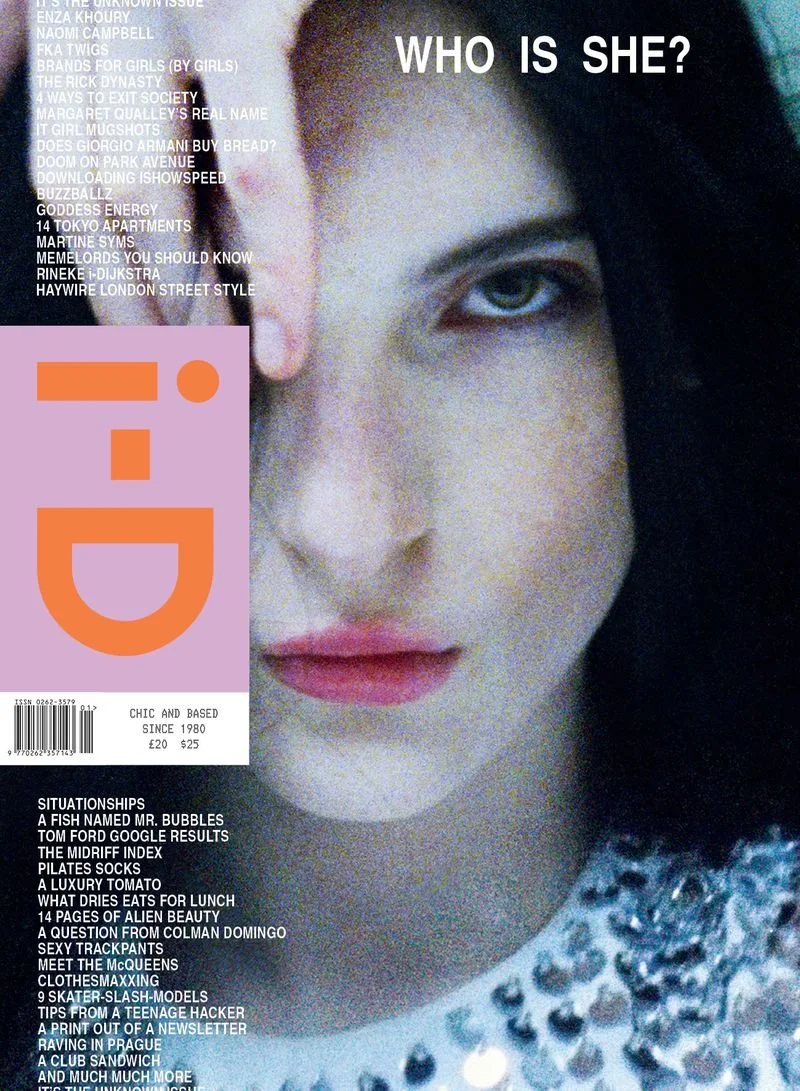 Magazine cover for i-D featuring a close-up portrait photograph of a face with grain and high contrast, dark hair partially obscuring the view.