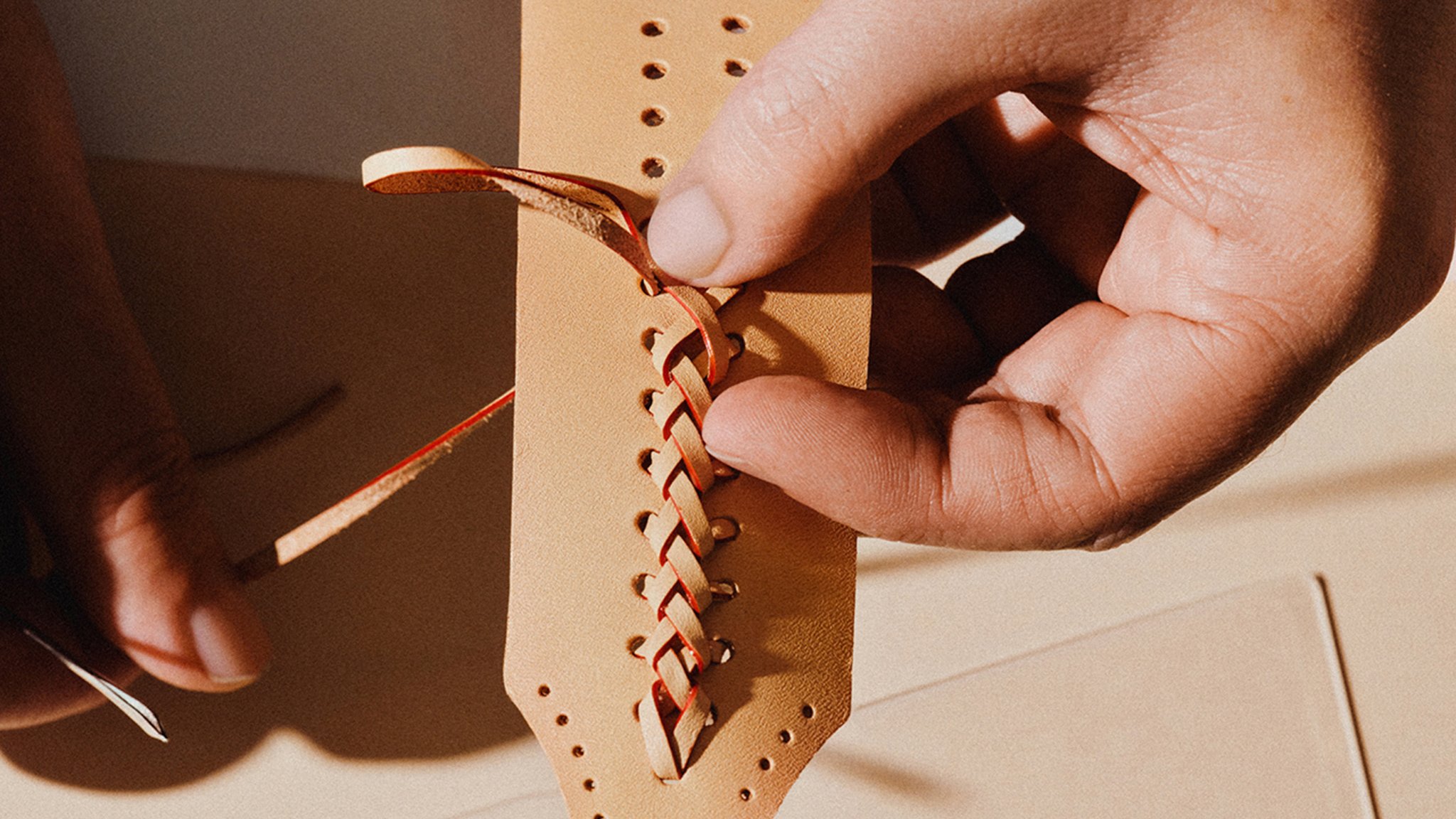 Hand-braiding of the natural tanned cowhide handle.jpg