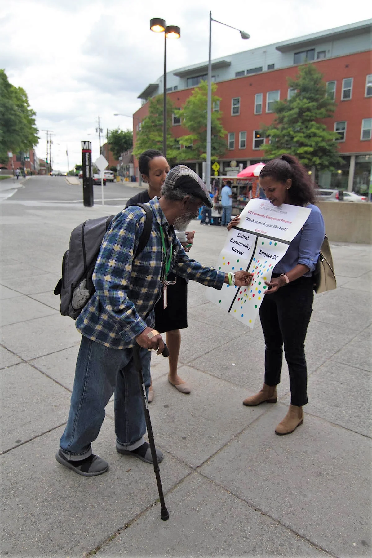 Lab team members outside a Metro station gathering resident feedback on what to name the survey platform (Credit: The Lab @ DC)