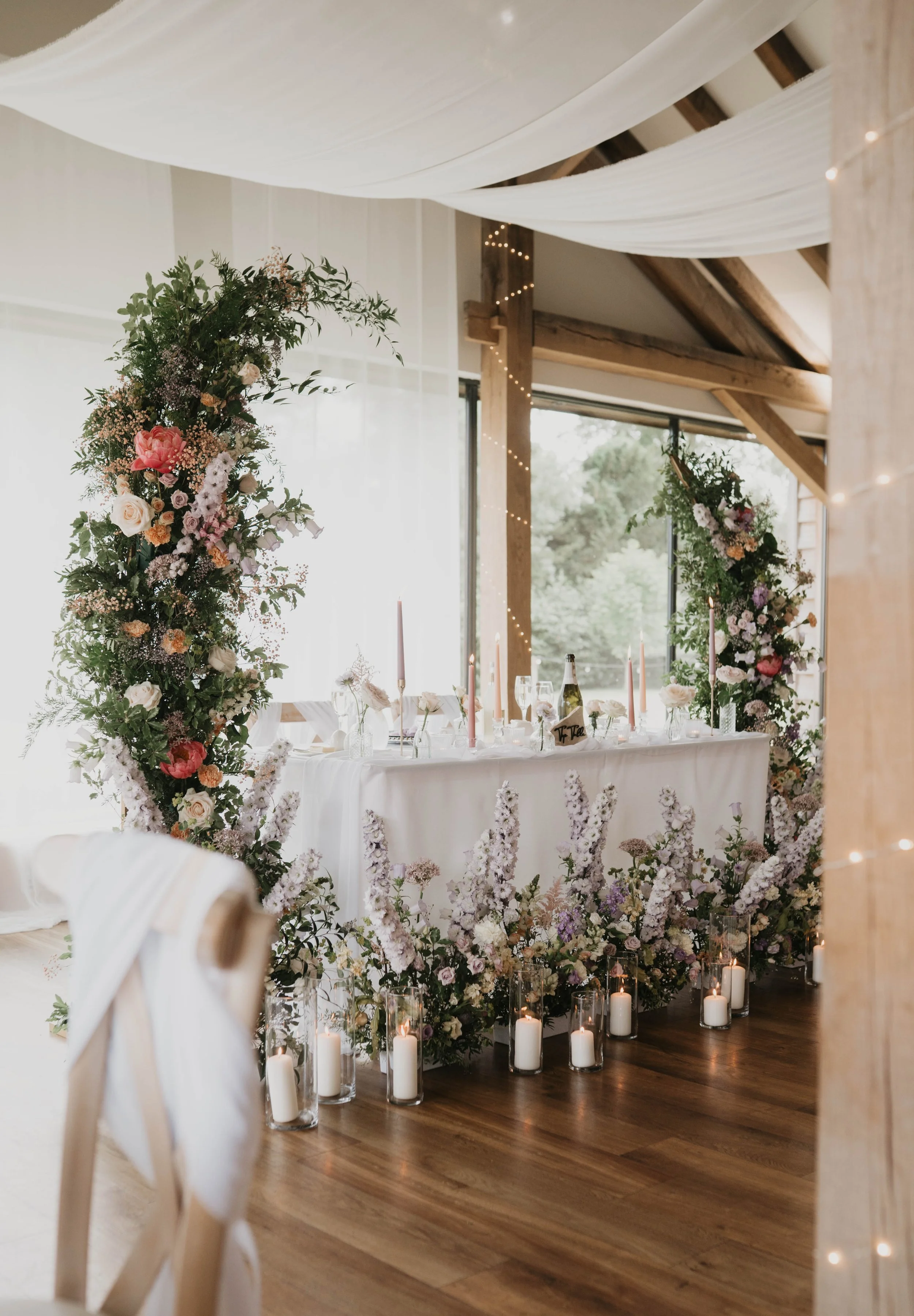 Top table styling with Backdrop flowers and candles in Herefordshire