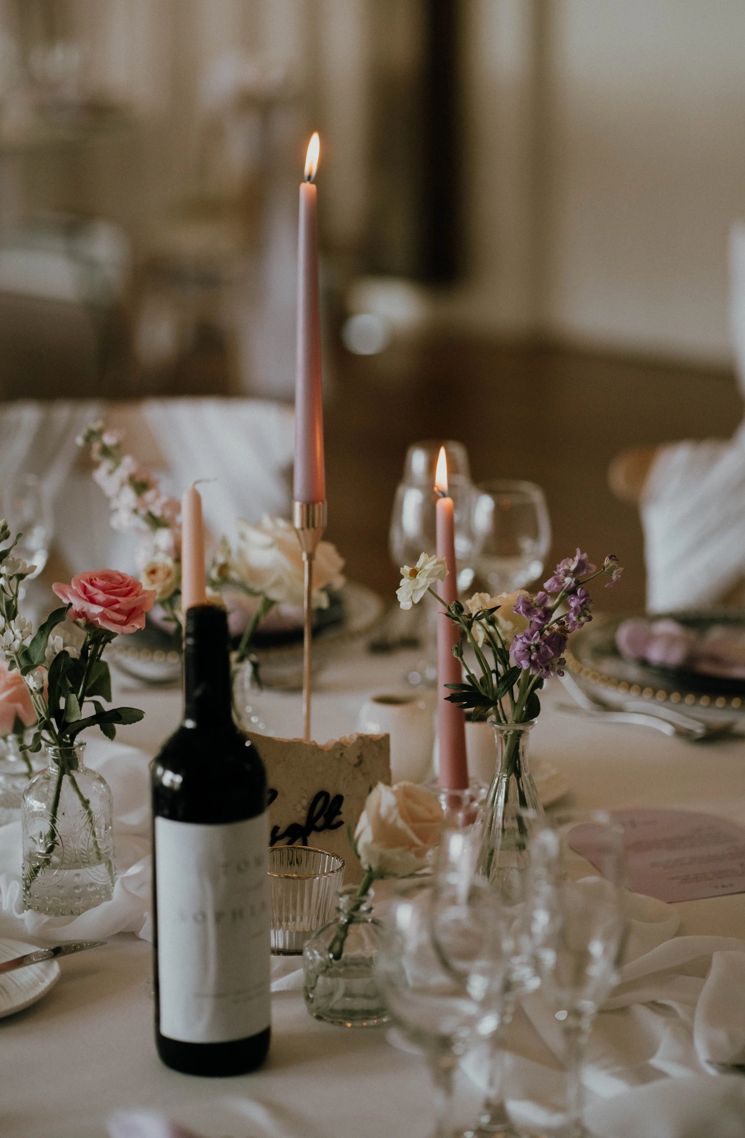 centrepiece with candles gold candsticks stone table number runner and flowers.JPG
