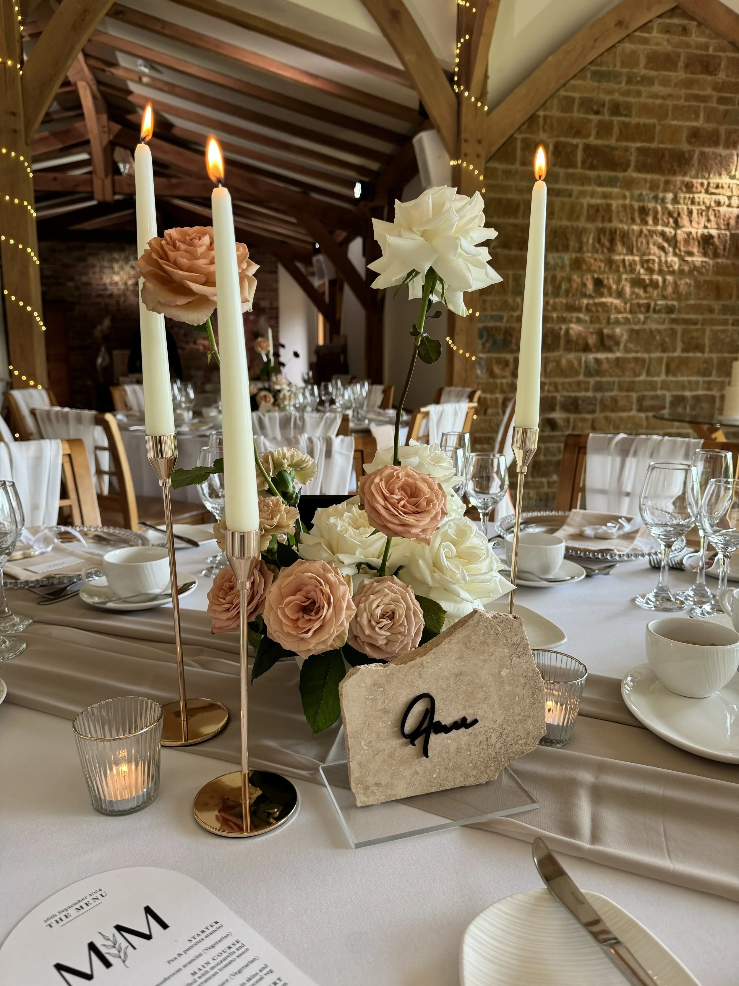 stone table number with flower and candle centrepiece in northampton
