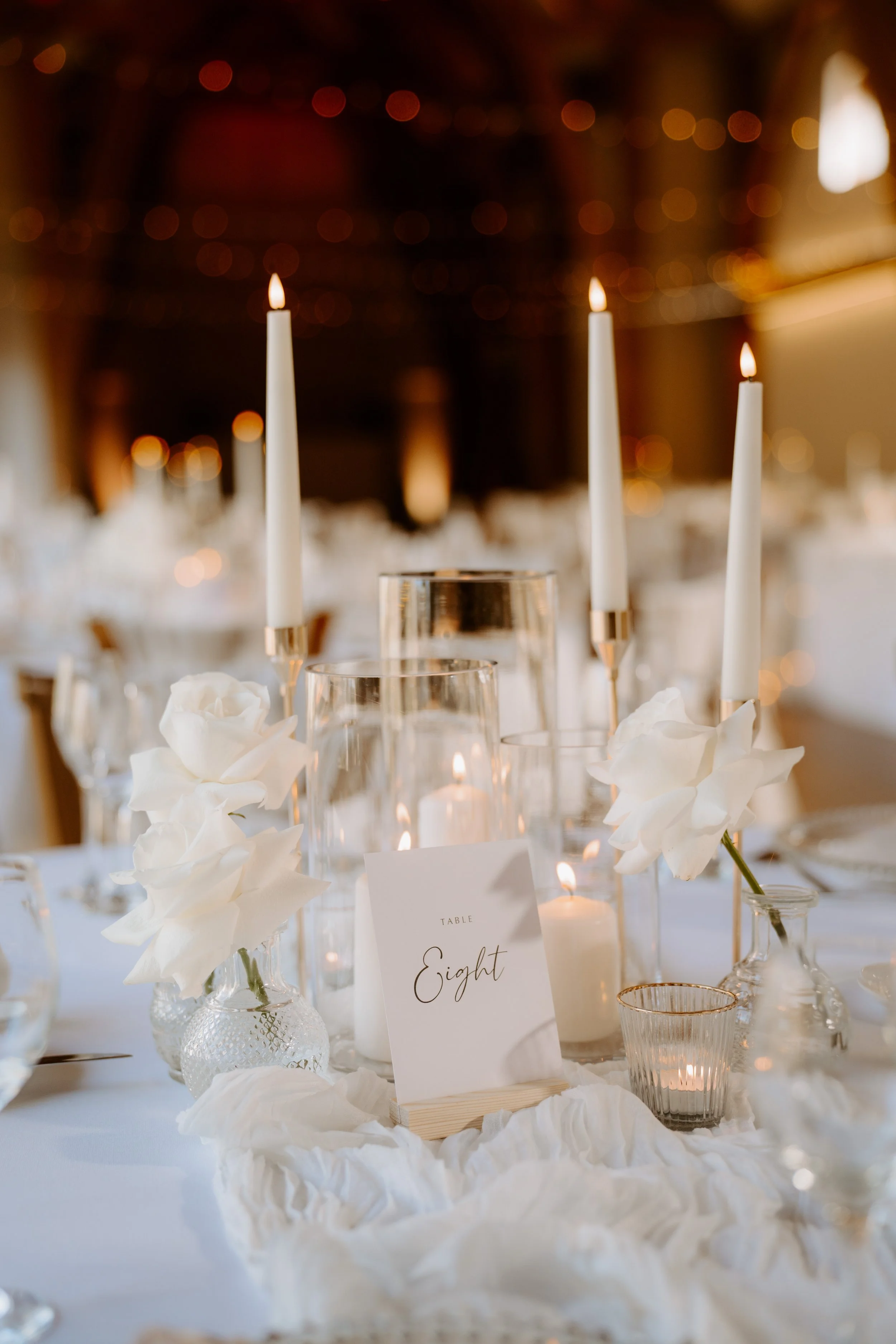 Wedding centrepiece styling with table runner candles, Flowers and table number
