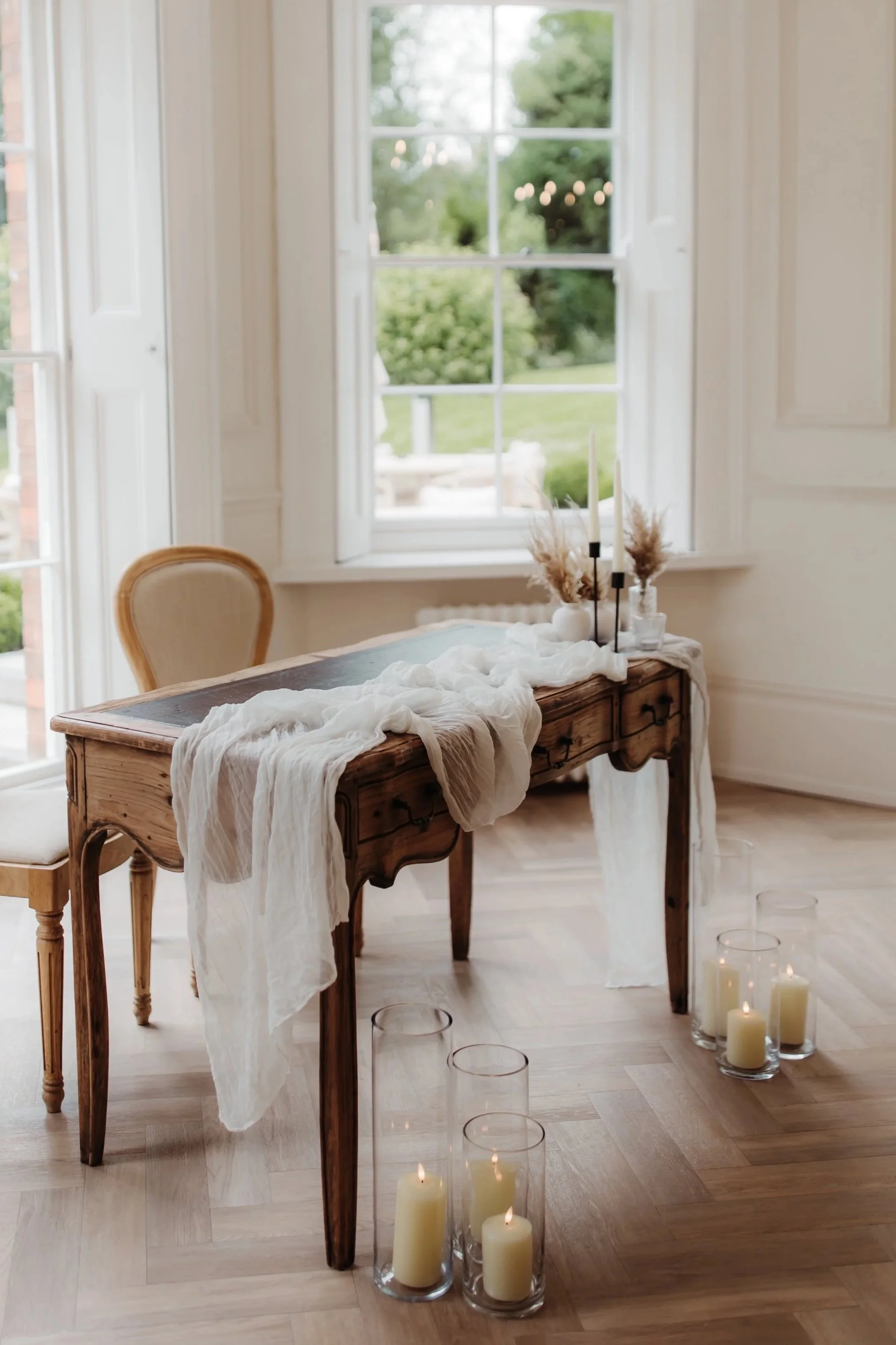 Ceremony decor with registrar table, table runner flowers, and candles