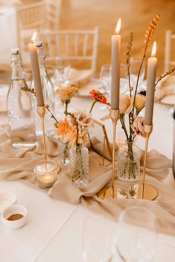 Wedding candle centrepiece with Flowers and table runner styling