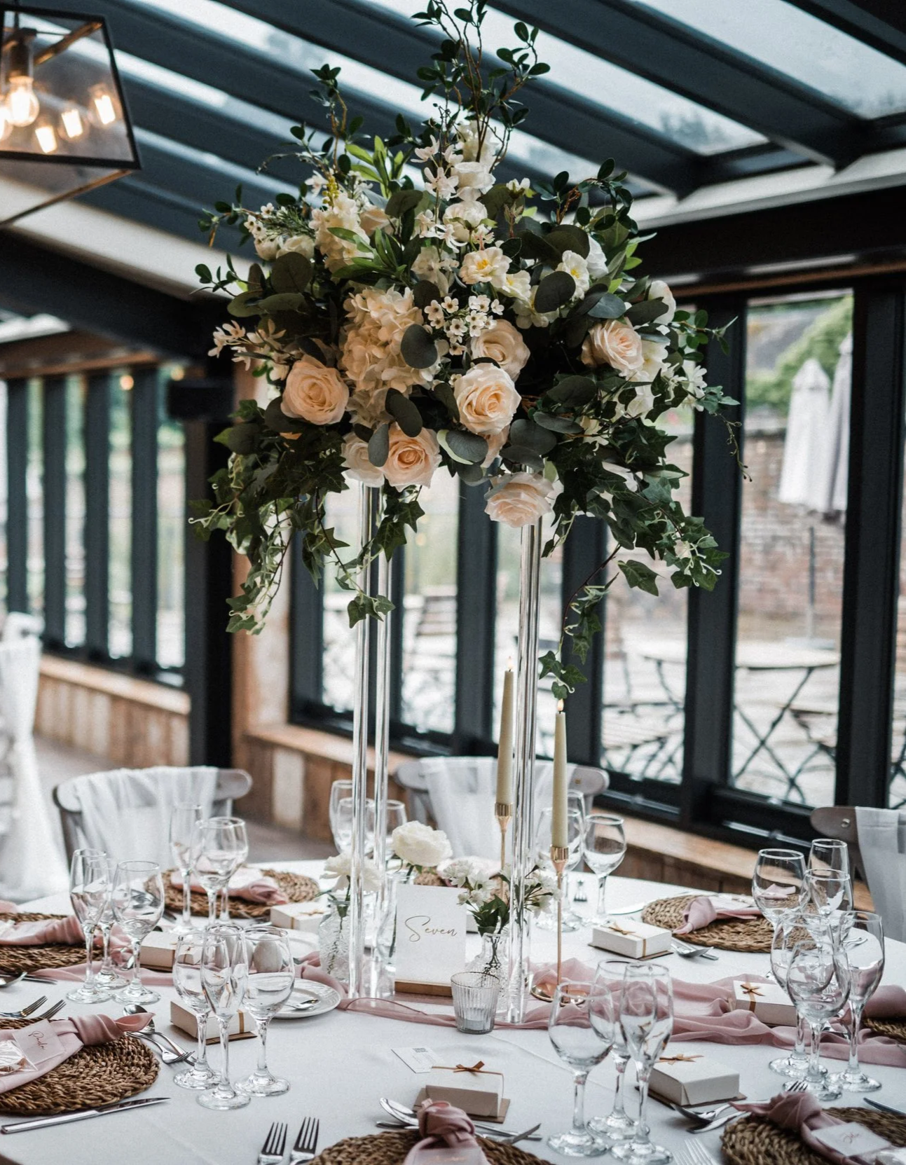 Tall Flower wedding centrepiece for wedding breakfast with table runner and chair drapes