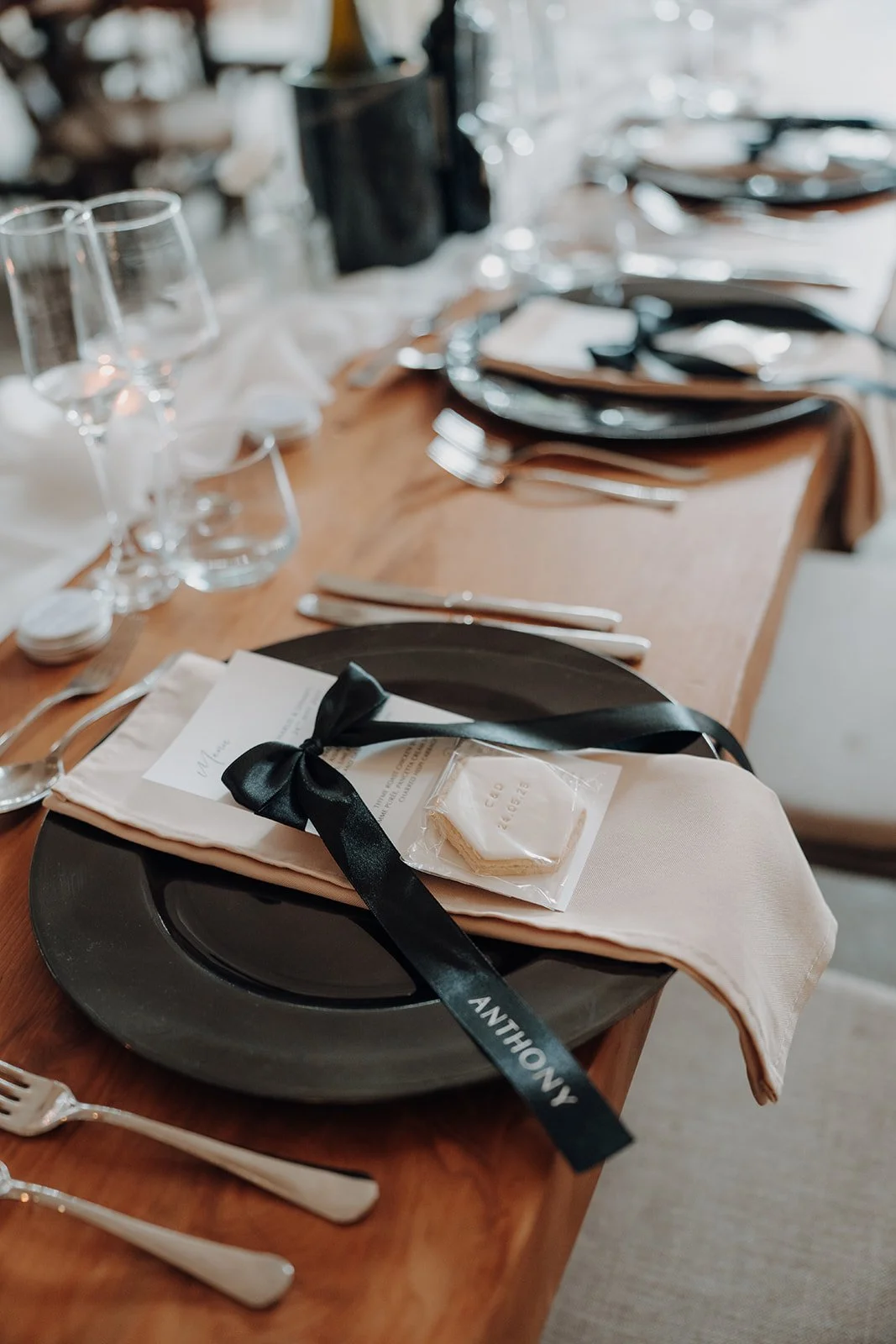Wedding table styling with charger plate napkin and bow place name