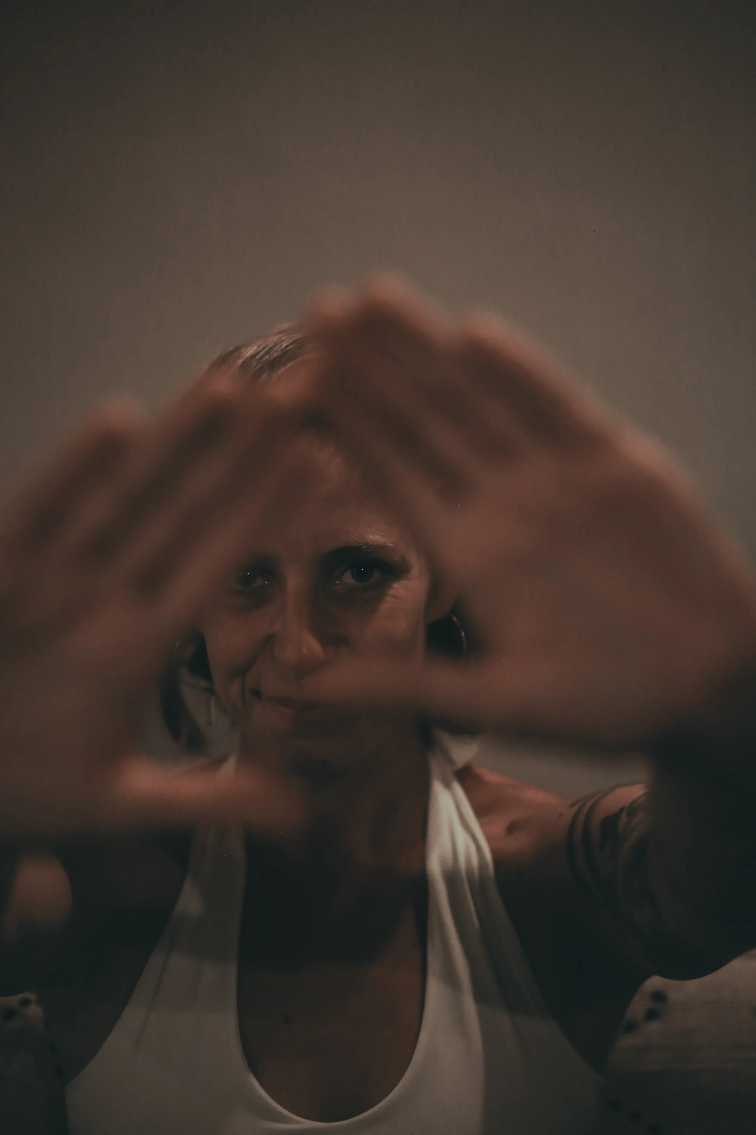 woman look at the camera between her hands