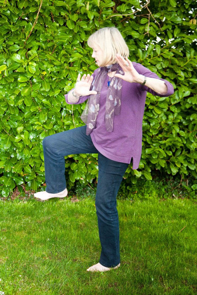 Senior woman doing tai chi.