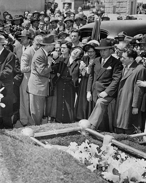 The wife of slain garment district worker William Lurye breaks down at his funeral in the Carmel Cemetery in Cypress Hills, Queens. She is supported by David Dubinsky, President of the International Ladies Garment Workers Union. (Photo by George Torrie/NY Daily News Archive via Getty Images)
