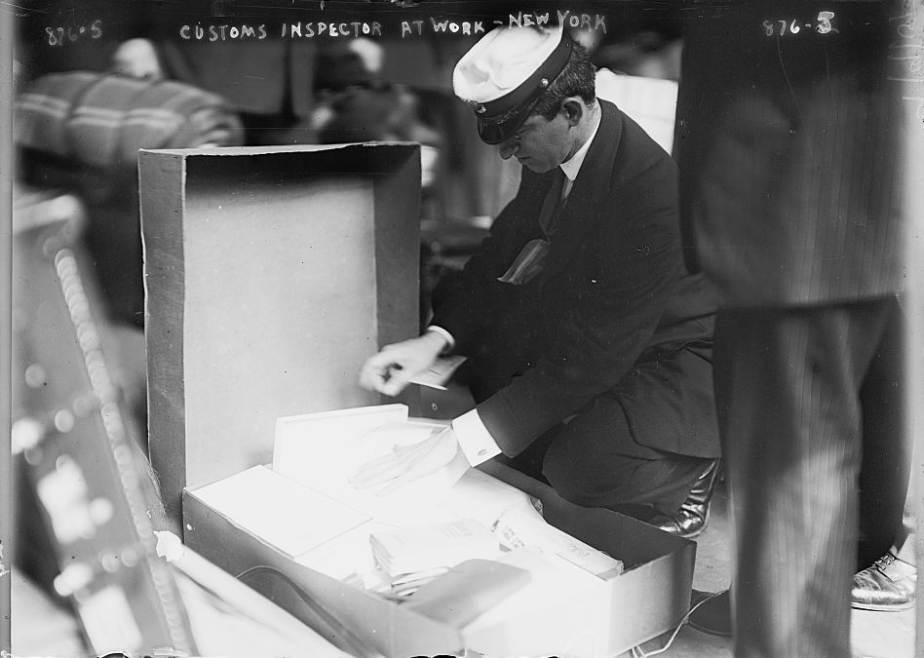 Figure 3: Customs Inspector at Work, NDL pier, New York, 1909. Library of Congress.
