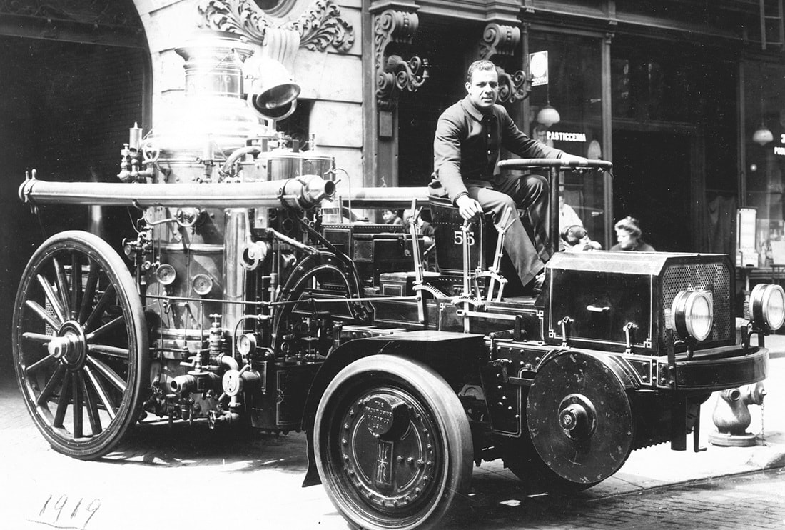 Wesley Williams driving an early fire engine, ca. 1920. Photographs and Prints Division, Schomburg Center for Research in Black Culture, New York Public Library.