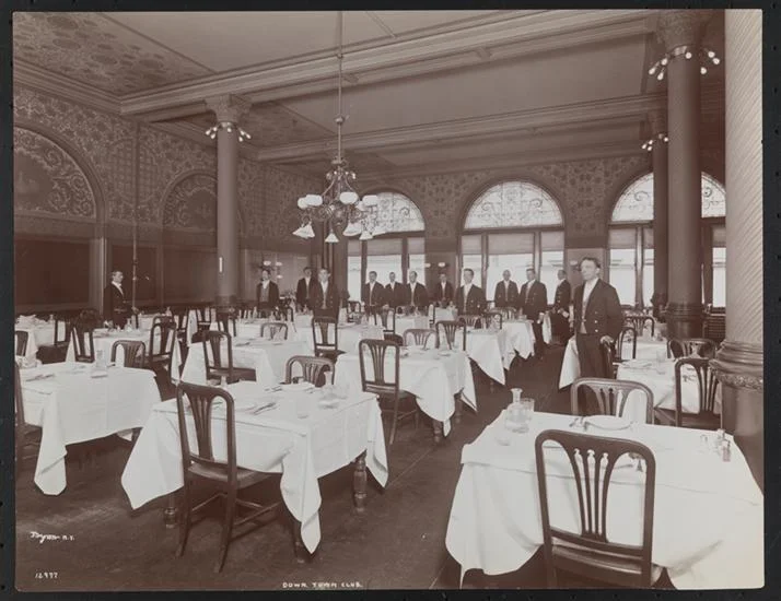 Waiters standing in the main dining room of the Down Town Association, Pine Street, 1902: Byron Collection, Museum of the City of New York. The Byron Collection includes several other behind-the-scenes photographs of the Down Town Association.