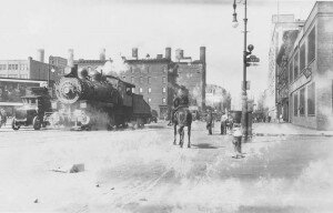 Steam engine on Eleventh Avenue, running through one of the most crowded neighborhoods in the city. (Milstein Division of United States History, The New York Public Library, Astor, Lenox, and Tilden Foundations)