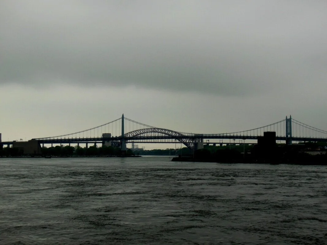 Hell Gate today, from Carl Schurz Park at about E. 88th Street, looking northeast toward the narrow channel between Hallett’s Point in Astoria on the right and Ward’s Island on the left. The rocks that used to be here would have occupied much of the river in the foreground. The dichotomy today is no longer heaven and hell, but the countervailing arches and cabling of the Hell Gate and Triborough bridges. (Photograph by the author.)