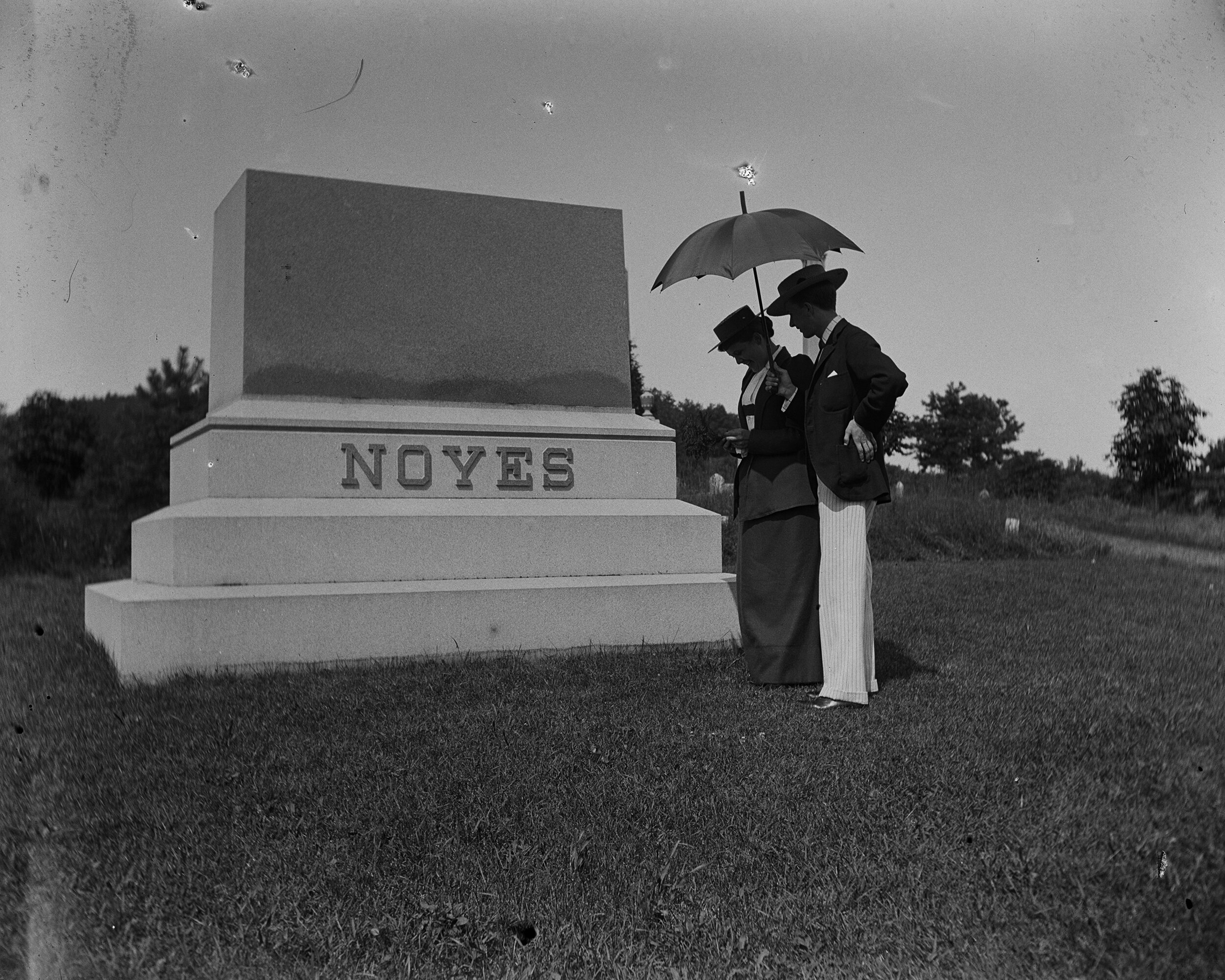   Tombstone Trude &amp; Mr. Hopper approaching the tombstone  Collection of Historic Richmond Town, 50.015.5464 