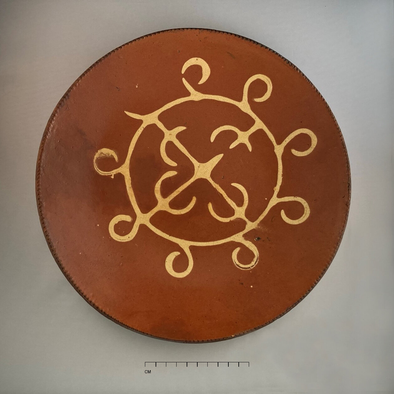   Redware plate (c.1805–1860), Huntington pottery, from Preservation Long Island’s local redwares collection.  Photographed by Allison McGovern 