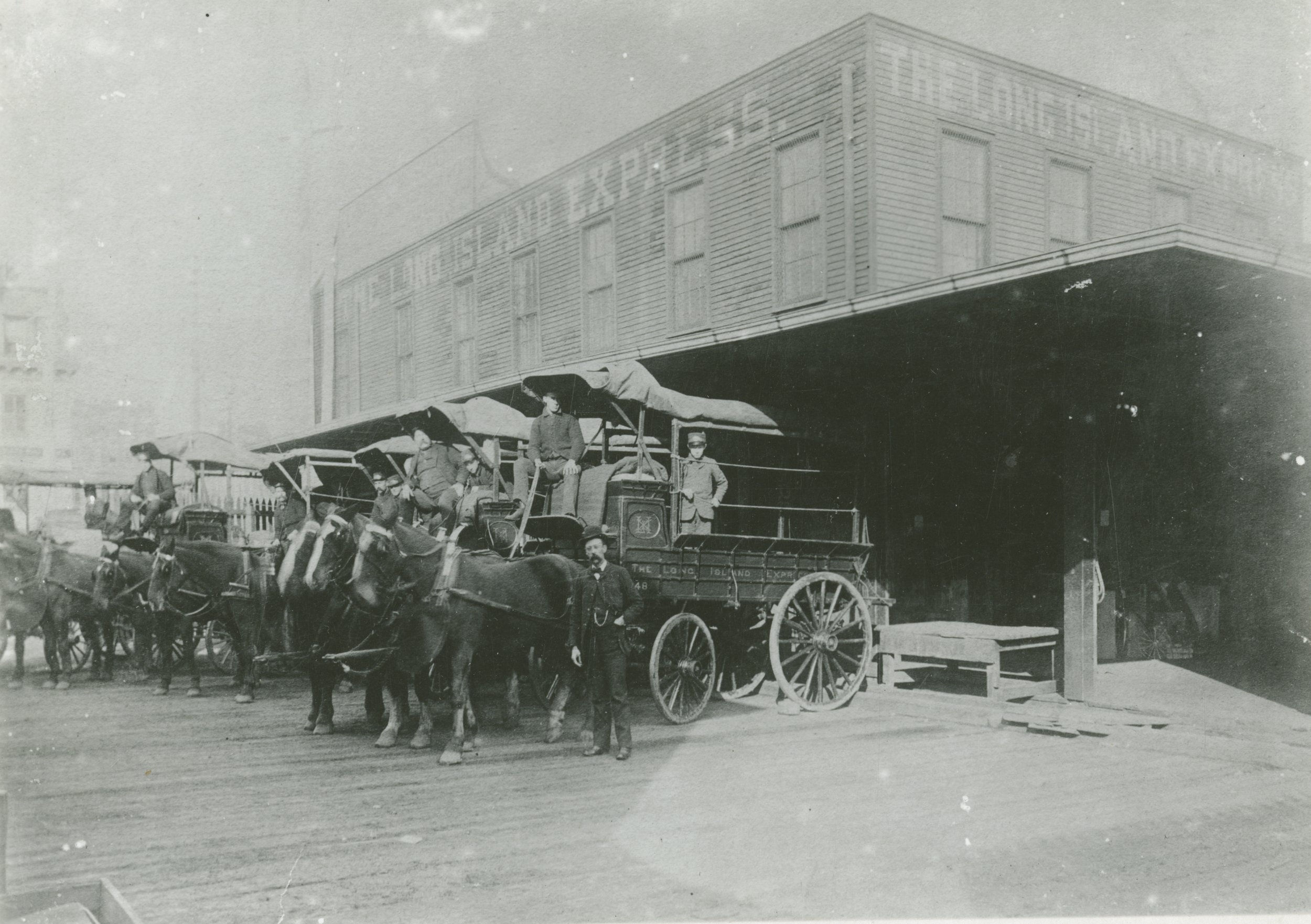  Drivers of the Long Island Express Company pose with their horse-drawn carriages for a group portrait in Long Island City, circa 1890. The express service was indispensable to the railroad's business model.  William J. Rugen Image Collection. Courte