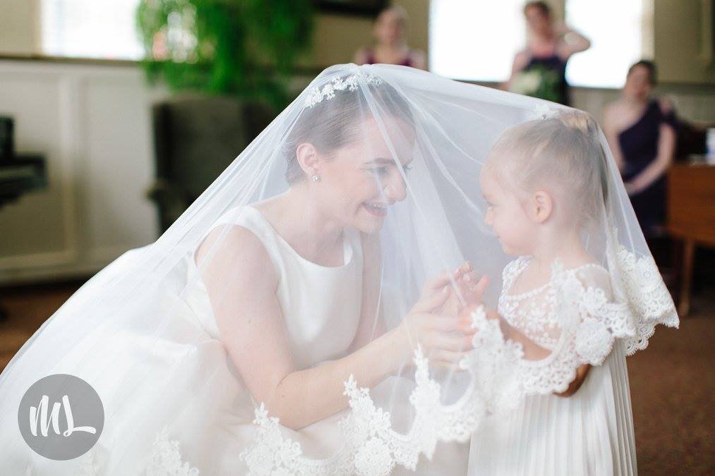 Bespoke couture bride with custom designed cathedral veil with flower girl.jpg
