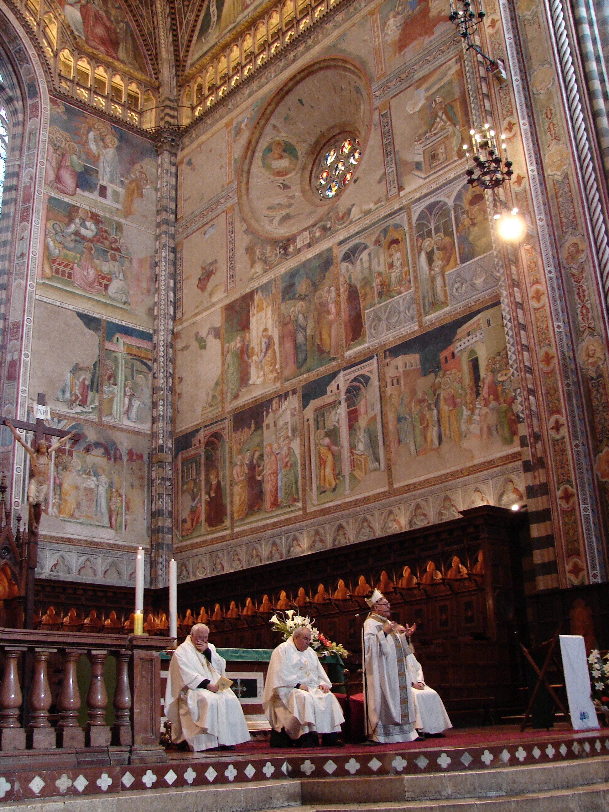  Bishop Scanavino (or Padre Giovanni, as he liked to be called) preaching with scenes from the life of Mary in the background, frescoed in the 1370s by Ugolino di Prete Ilario 