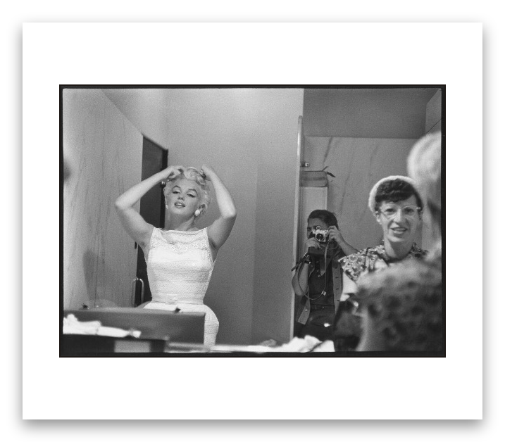 Marilyn Monroe in the mirror of a public bathroom along with Eve Arnold and a woman surprised to find herself next to the star. Chicago, USA. 1955.