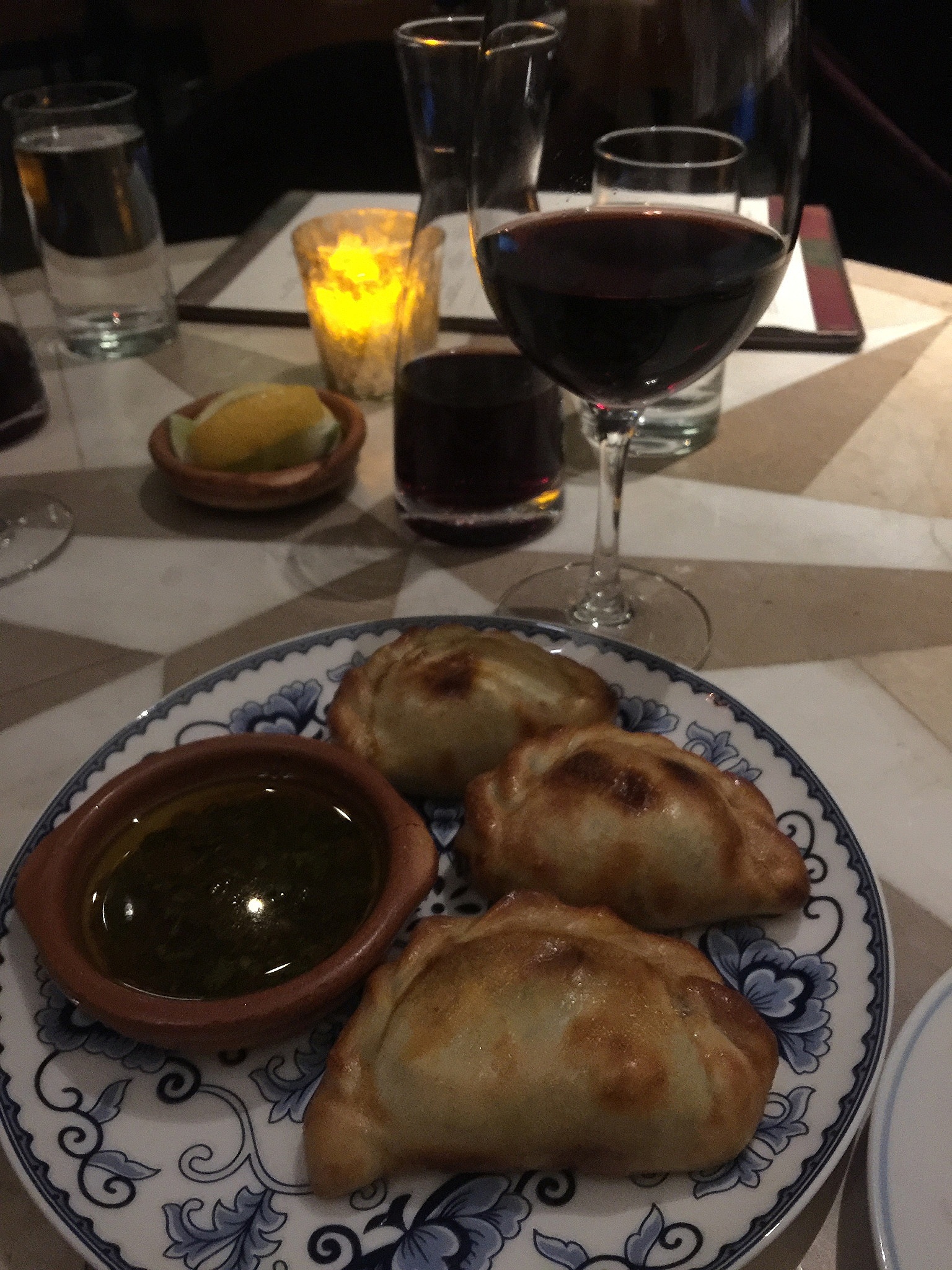 emapanadas with chimichuri and glass of red wine 